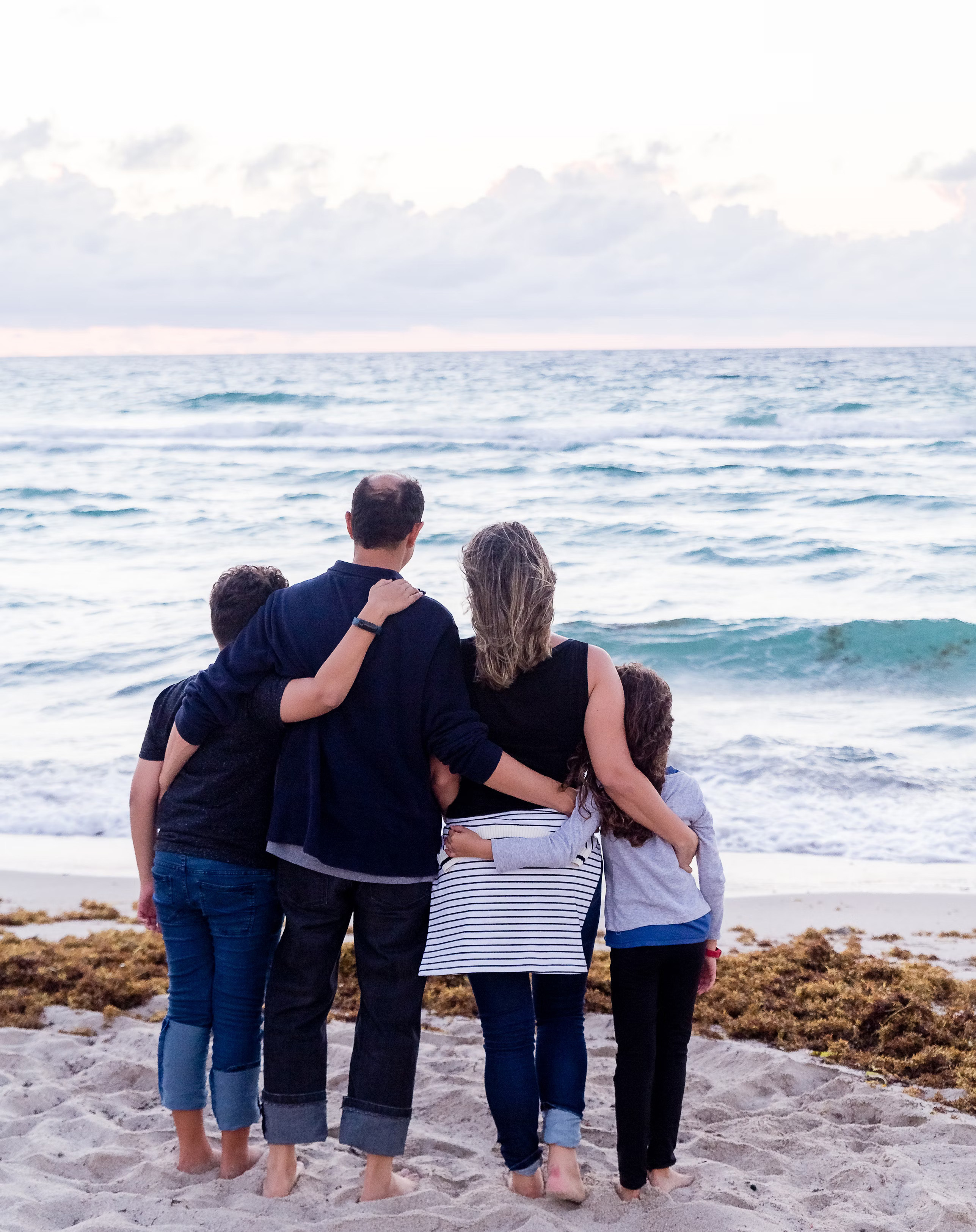 Happy family enjoying time at the beach, representing financial security and peace of mind through comprehensive life insurance coverage